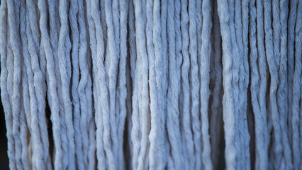 Close-up of a blue cotton yarn. Abstract background and texture.