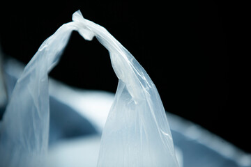 close up of plastic bag on black background, concept of environmental pollution