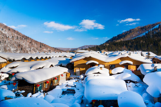 Iconic thick "mushroom" snow formations on rooftops of a traditional village in Xuexiang (Snow Town), Heilongjiang.