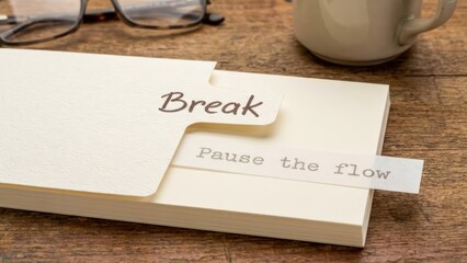 A paper card with the word break during a work pause on a desk