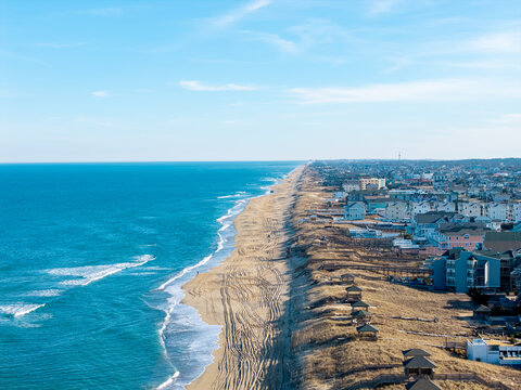 Kill Devil Hills, North Carolina, aerial view of the Atlantic coastline featuring sandy beaches, vacation homes, and the expansive Outer Banks landscape.