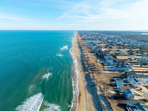 Kill Devil Hills, North Carolina, aerial view of the Atlantic coastline featuring sandy beaches, vacation homes, and the expansive Outer Banks landscape.