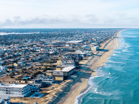 Kill Devil Hills, North Carolina, aerial view of the Atlantic coastline featuring sandy beaches, vacation homes, and the expansive Outer Banks landscape.