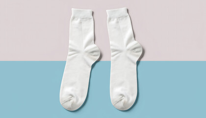 A pair of white socks with bow details lying on a pastel colored surface