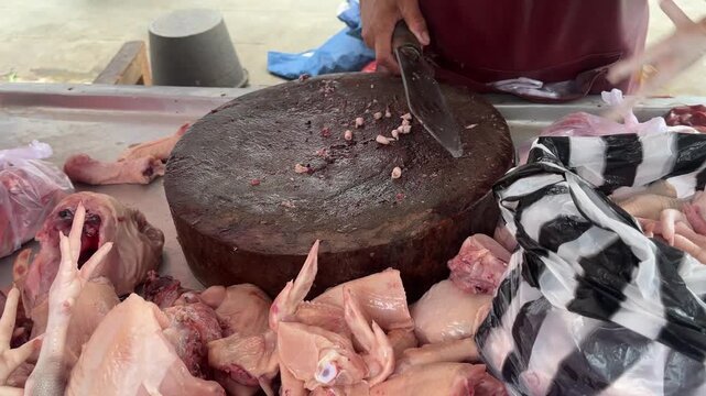 butcher cutting meat on the grill