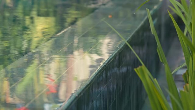 Water overflow of tropical infinity swimming pool, still abstract calm luxury scene