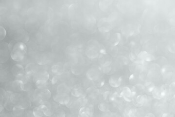 Abstract silver glitter sparkle texture with bokeh background © Kwangmoozaa