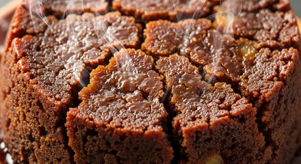 Close Up Of A Steaming Chocolate Pudding Dessert With A Rich Brown Texture And Caramel Glaze On A Wooden Surface