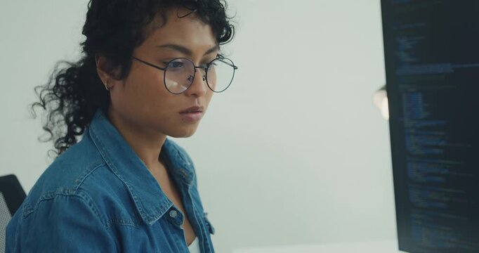 Close-up young professional African American female programmer coding AI software on screens in modern home office. Generative AI, machine learning, digital innovation, future technology concept.