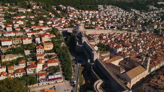 Epic Dubrovnik Minceta tower game of thrones aerial. 
Cinematic 4K drone wall tracking and orbit 
around historic medieval fortress 
and old town roofs in Croatia.
