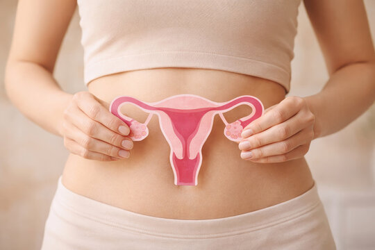 Female reproductive health polycystic ovary syndrome awareness woman holding uterus diagram abdominal pain hormone imbalance medical concept support care