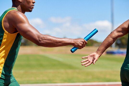 Athletes passing relay baton during track and field race