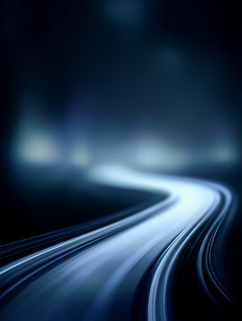 Abstract light trails on a dark background create a winding path, evoking a sense of motion and depth in a visually striking composition