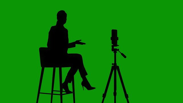 Silhouette of Woman in Formal Outfit Hosting Talk Show Style Live Stream on Green Screen Chroma Key, Professional Mobile Media Production and Business Webinar Concept