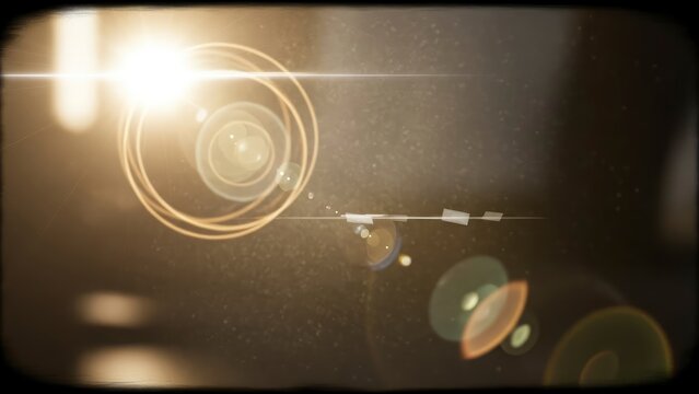 Brilliant lens flare with golden light rings and subtle dust, creating a captivating and warm abstract background or overlay effect.