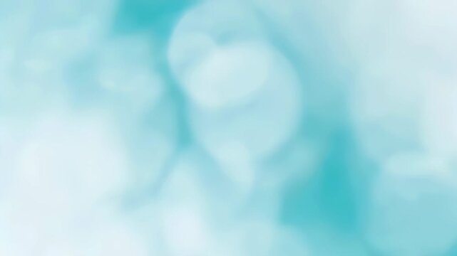 Shimmering bokeh light movement on a light blue background. Abstract blurred water effect for festive or calm design.