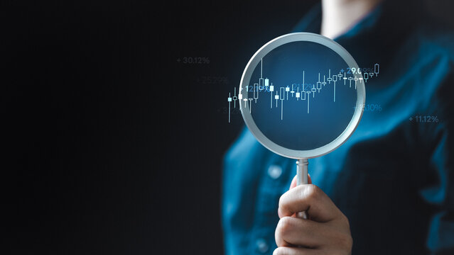 Stock market analysis concept with magnifying glass and financial data chart. Represents investment research, trading strategy, market trends, performance analysis, and economic insight.
