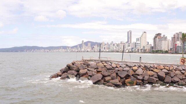 Itapema, Brazil: A view of the coastline with a rocky breakwater