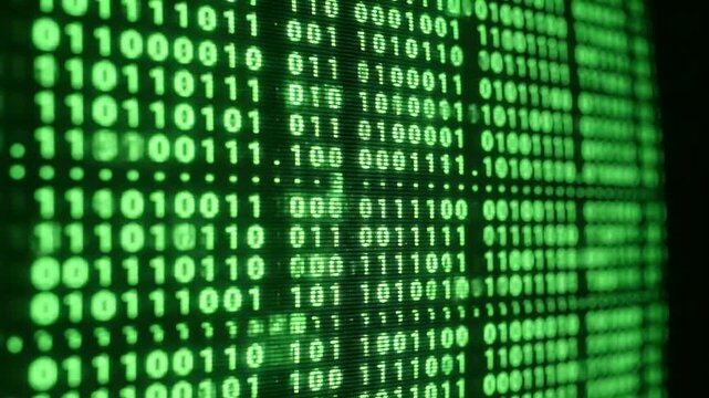 A video showcasing a close-up of green binary code on a computer screen