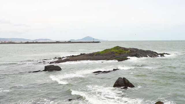 Rocky outcrop with waves crashing near Atalaia, Itajai, Brazil
