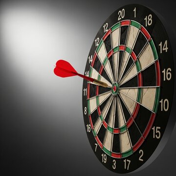A red dart is embedded in the bullseye of a dartboard with numbered sections