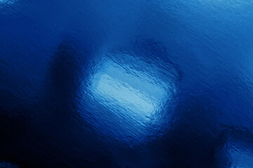 Fototapeta premium Abstract blue reflection on a glossy surface with cyan light and textured ripples, perfect for modern backgrounds