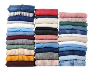 Three neat stacks of folded clothes, various colors and textures, isolated on a bright white background