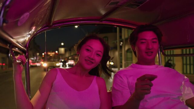 Romantic Asian Couple Enjoys Night Tuk Tuk Ride in Bangkok