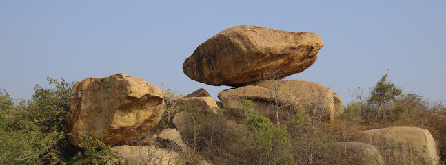 Big balancing granite boulder in Sanapur, villige near Hampi, India. © u.perreten