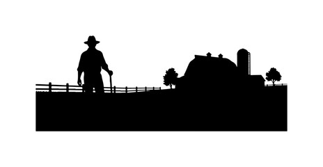 Silhouette of Cowboy Standing on Fence Near Barn