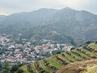Terraced vineyards and the village of Kalopanayiotis from above, stone houses and green valley in the Troodos Mountains of Cyprus