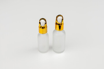 Minimal Frosted Glass Serum Bottle with Gold Dropper Cap on White Background
