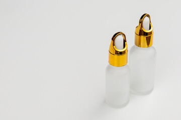 Minimal Frosted Glass Serum Bottle with Gold Dropper Cap on White Background