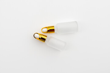 Minimal Frosted Glass Serum Bottle with Gold Dropper Cap on White Background