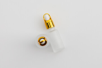 Minimal Frosted Glass Serum Bottle with Gold Dropper Cap on White Background