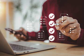 Businessman is digitally checking off a list of tasks or documents on a virtual screen, symbolizing...