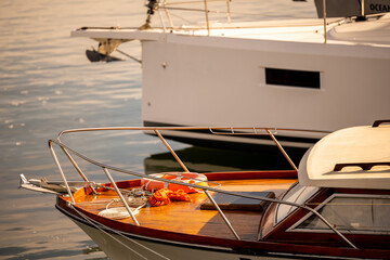 Wooden motorboat bow with safety equipment in marina