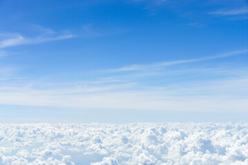 Fototapeta premium Minimal aerial scene of blue sky and soft white clouds, serene background with copy space