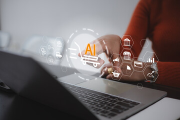 Close up of a businesswoman using a laptop with an AI shopping cart icon, representing smart retail technology, digital marketing, and automated e-commerce solutions in a modern office. © Thawatchai Images