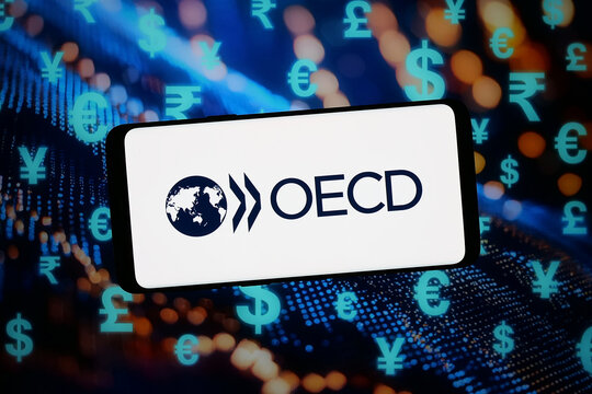 Stuttgart, Germany - 02-11-2026: In this photo illustration, the logo of economic development organisation OECD is displayed on a smartphone in front of abstract background on computer screen.
