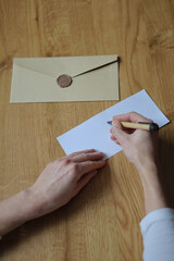 Obraz premium Letters, postcards, leaflets. Sending and receiving letters. Greetings to the family, close people. Writing letters, postcards, leaflets. Beige envelope, pen. 