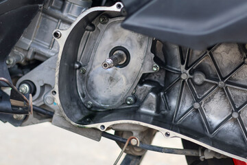 Fototapeta premium Internal view of an open motorcycle CVT engine case showing the crankshaft spline and transmission housing during a professional mechanical service or repair at a workshop.