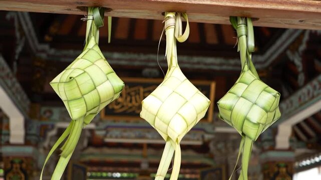 Three Green Woven Bags Hanging from Beam.