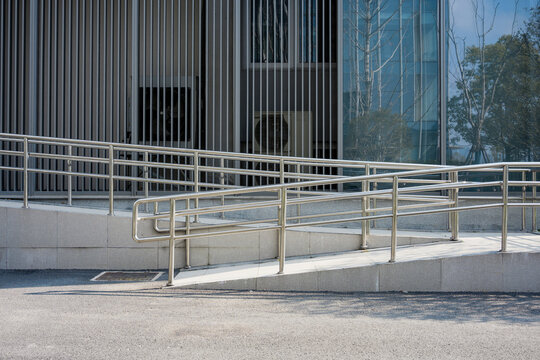 Modern building exterior with accessible ramp and metal handrails