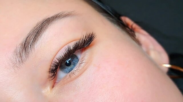 Close up of female eye with eyelash extensions ,eyelash extension procedure.2d volume, 3d volume, classical lashes,Russian volume,mega volume, new set.