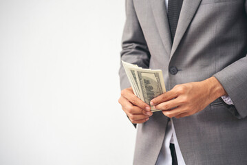 Backside Businessman spreading 100 dollar banknote in back jeans pocket. Hand holding loan money dollar bank note payment. Close up Man hands spread 100 dollar exchange cash. Bribe corruption concept