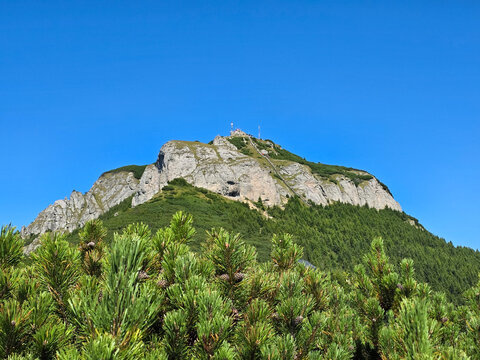 Toaca Peak, Ceahlău Massif, Romania. The distinctive pyramid-shaped peak (1904m) is a popular attraction featuring a meteorological station and stairs to the summit.