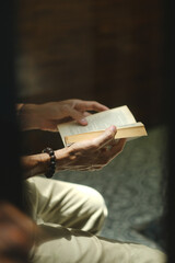 Obraz premium Man Reading an Open Book in Beautiful Morning Light