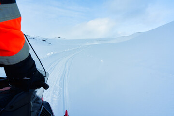 Snowmobile riding through arctic snowy landscape in winter © Mumemories