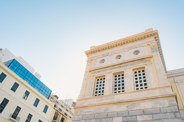 Fototapeta premium Classical Limestone Building Meets Modern Glass Facade, Low Angle